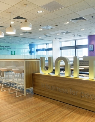 office fitting out custom furniture workstation aetrio timber series chair and soft seating at Unit4 Indonesia Office